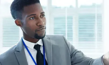 Criminal Justice Bachelor's Degree Graduate Working on Case on Whiteboard